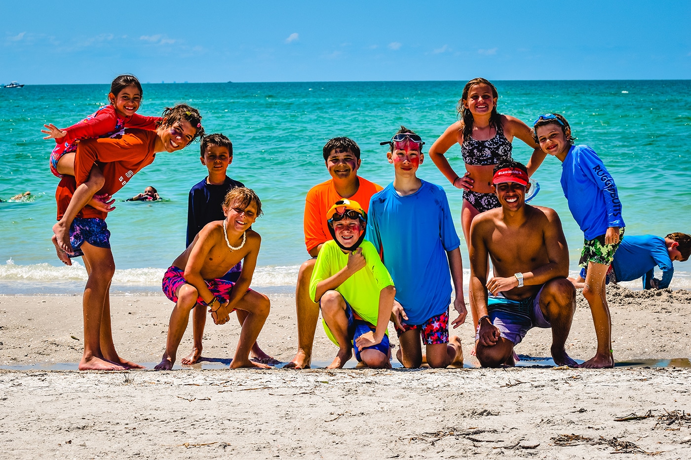 image of group of people on a beach smiling