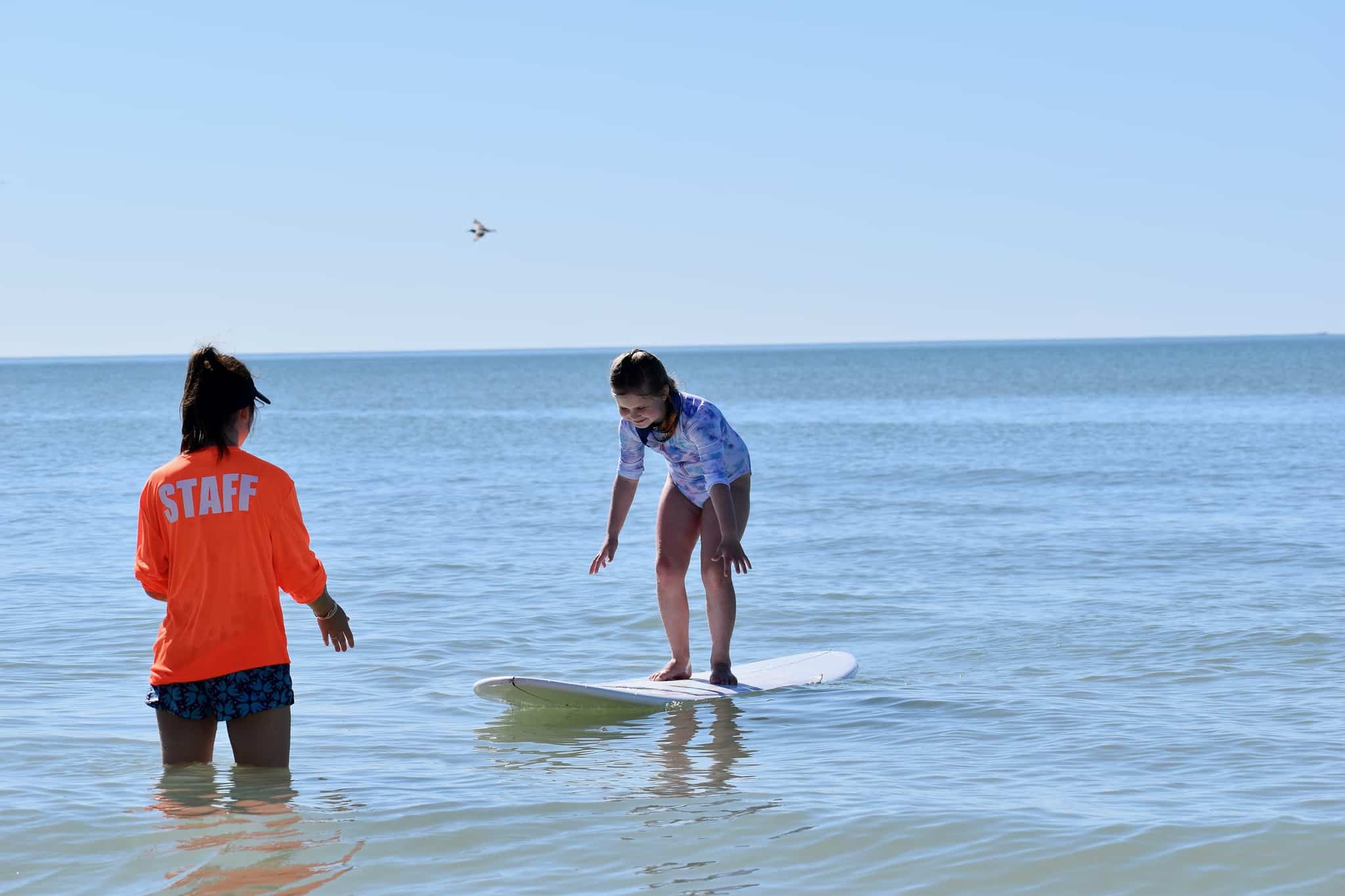 image of child standing up on surf board
