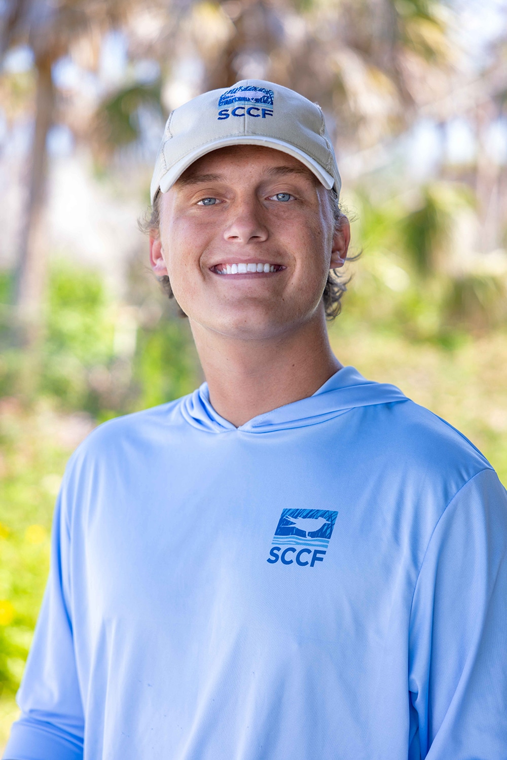 man smiling in sccf hat and shirt