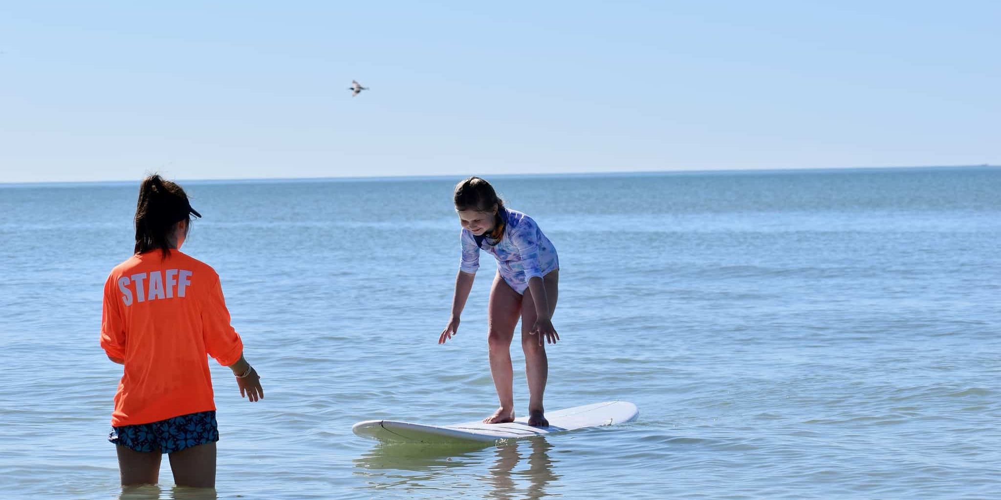 image of child standing up on surf board
